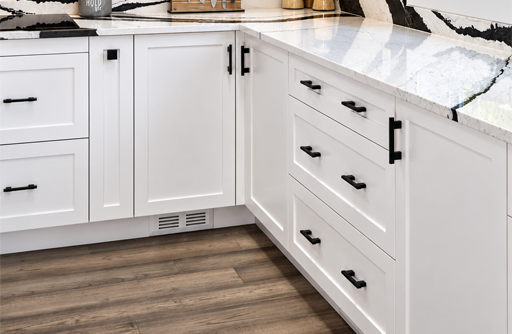 Modern White Kitchen Cabinets with Black Handles and Marble Countertop